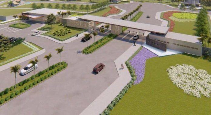 Imagem aérea de projeto de bairro planejado, com portaria central com entrada e saída de veículos